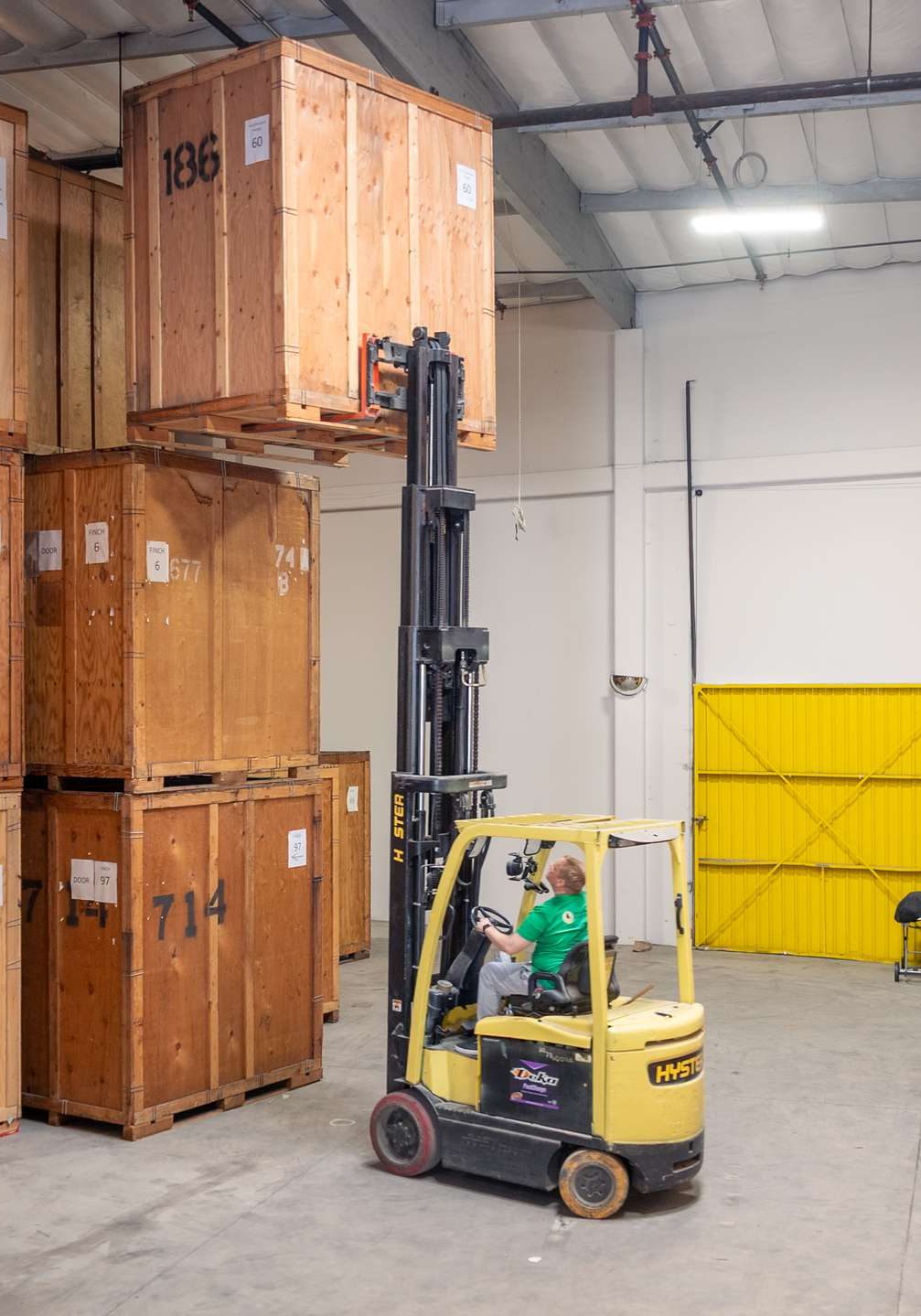 our team forklift stacking storage crates in the warehouse